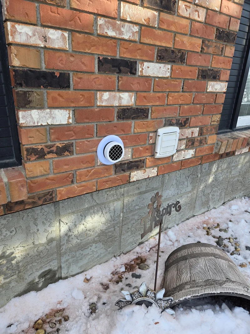 An exterior radon exhaust vent installed by Sask Air Solutions